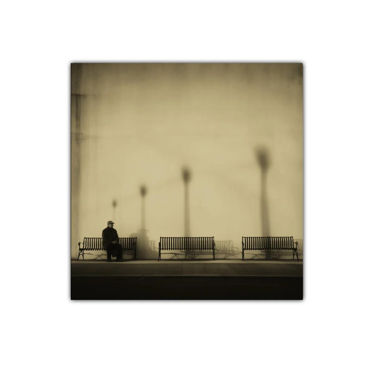 Paisaje urbano melancólico con bancos y figura solitaria — imagen principal